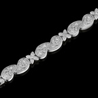 Silver bracelet with diamond accents on a black background